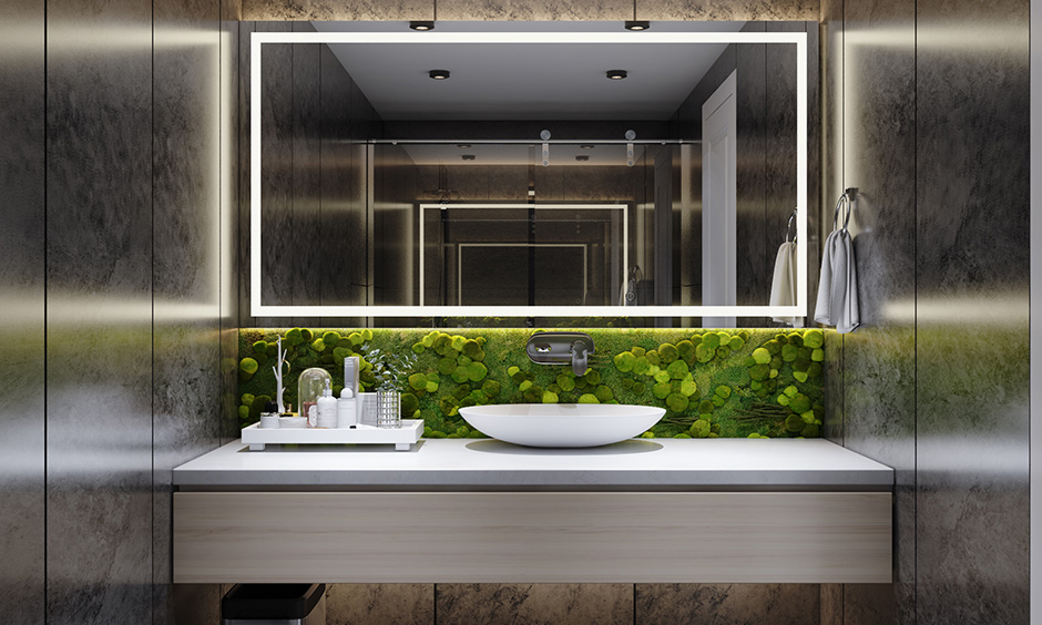 Black bathroom wall paint with a plant wall and the warm glow of focused lighting binds the space together seamlessly.